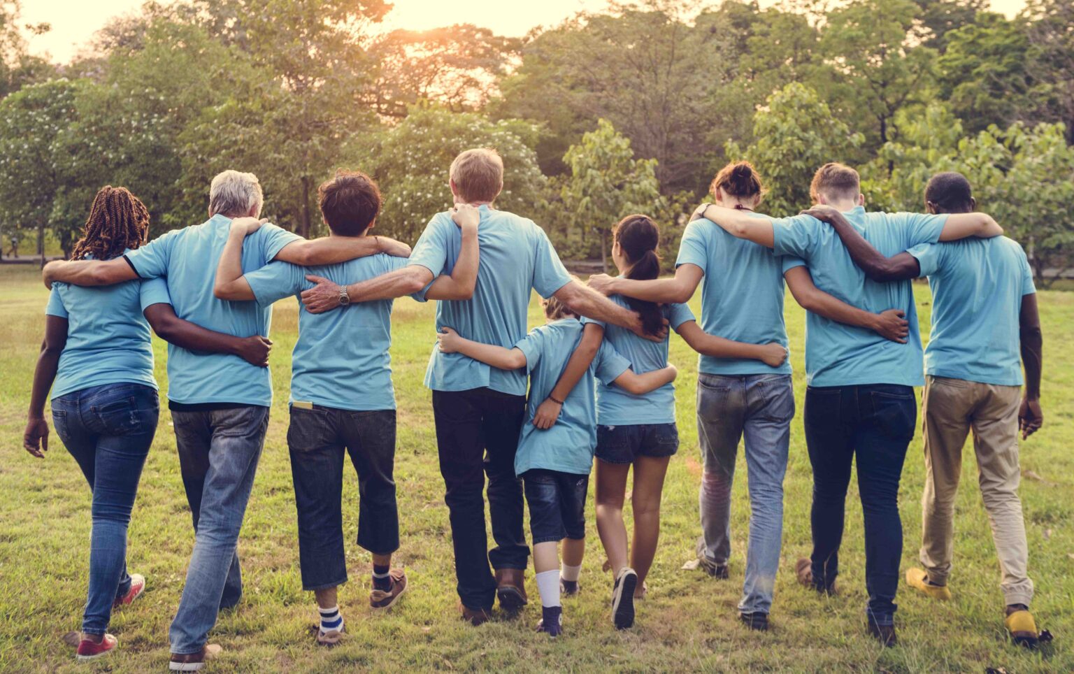 a group of people walking together arm-in-arm